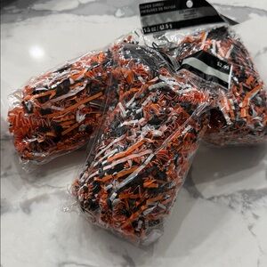 Three bags of black and orange shredded paper Halloween party bag material